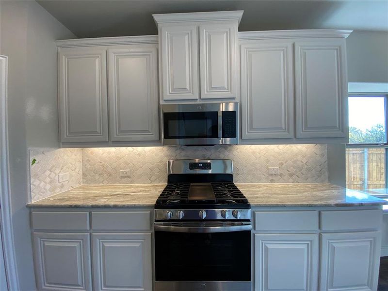 Kitchen offers ambiance with undercabinet lighting