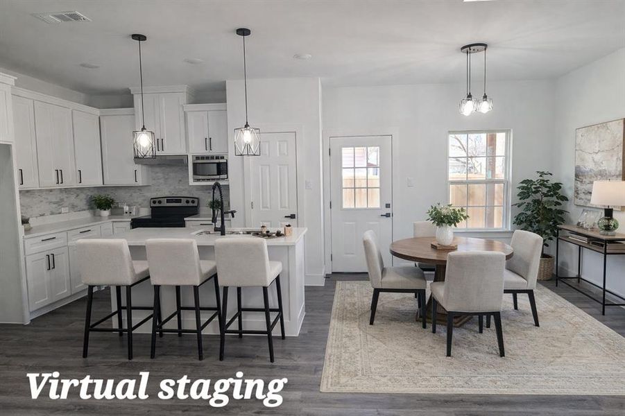 Kitchen featuring a kitchen island with sink, a breakfast bar area, stainless steel appliances, white cabinets, and dark wood-style flooring