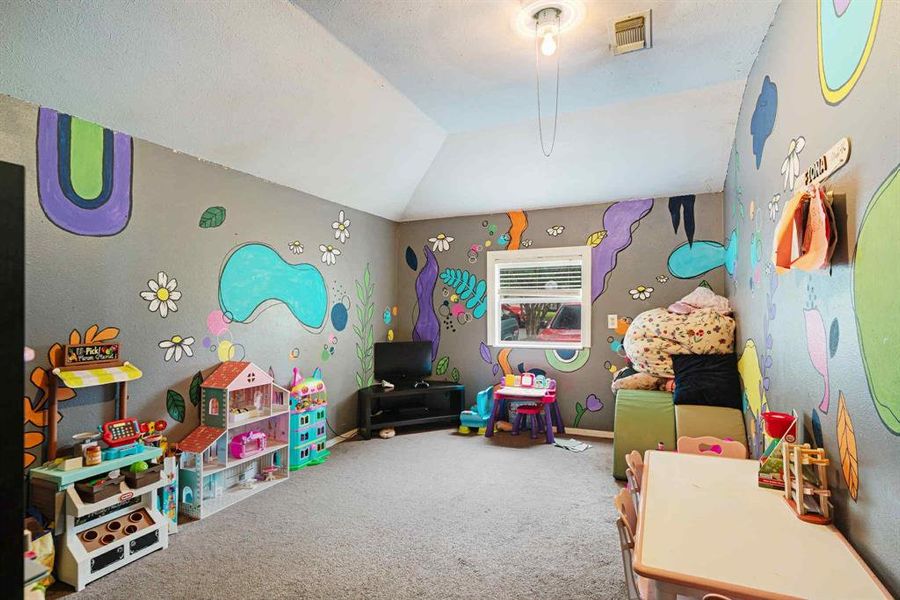 Game room with lofted ceiling and carpet floors Game room with lofted ceiling and carpet floors