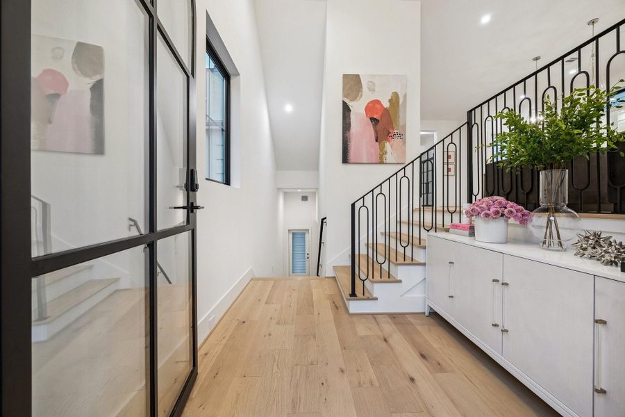 The entrance of the home makes a striking first impression with its clean, modern sophistication and airy scale.
