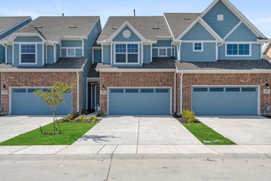 Front exterior of a new home in Woodbridge Townhomes, Wylie, TX, highlighting curb appeal (Image 25).
