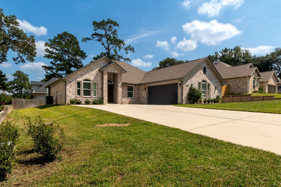 Front exterior of a new home in , Huntsville, TX, highlighting curb appeal (Image 16).