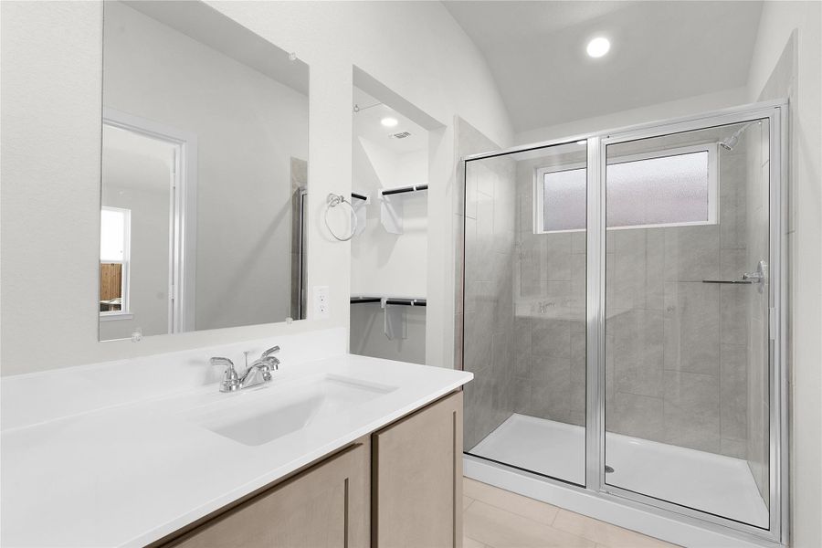 Bathroom featuring a shower stall and vanity