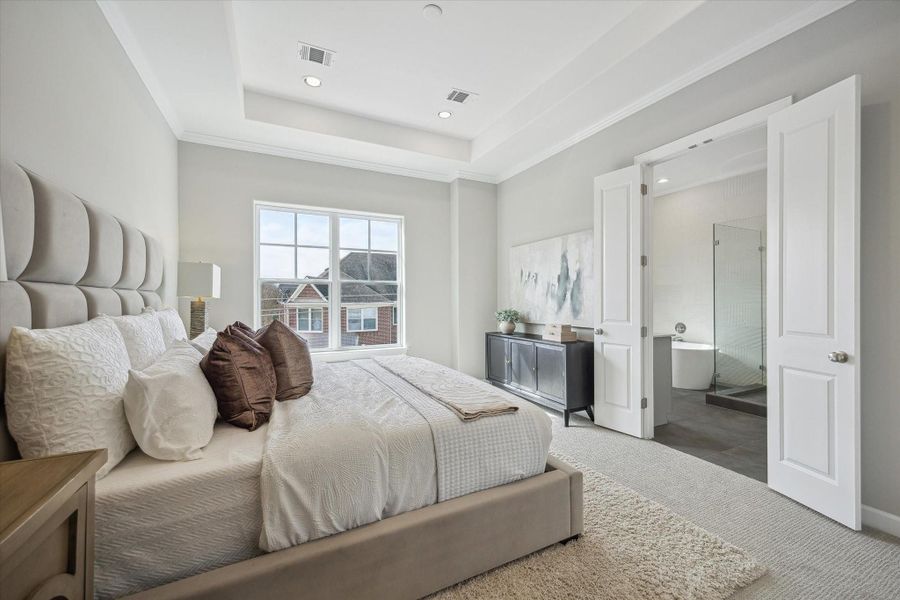 Primary suite features double French doors leading to the closet and bath.