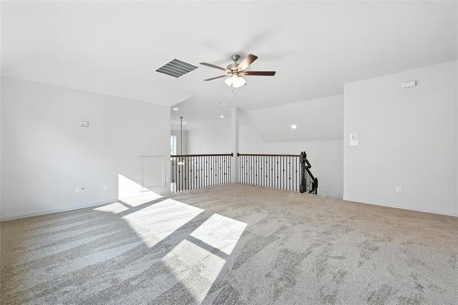 Unfurnished room with vaulted ceiling, light carpet, ceiling fan, and recessed lighting