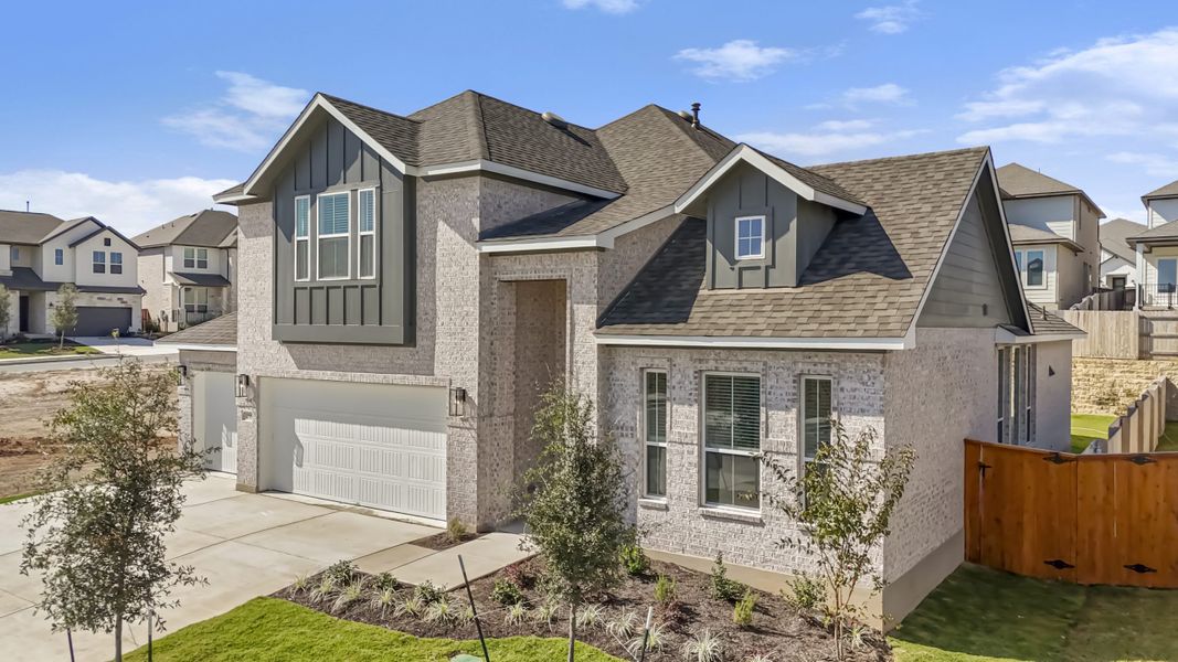 Front exterior of a new home in Santa Rita Ranch, Liberty Hill, TX, highlighting curb appeal (Image 27).