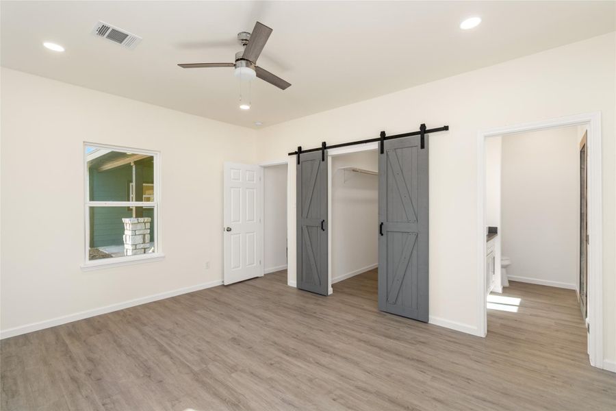 Stylish sliding barn door adds character and modern farmhouse flair.