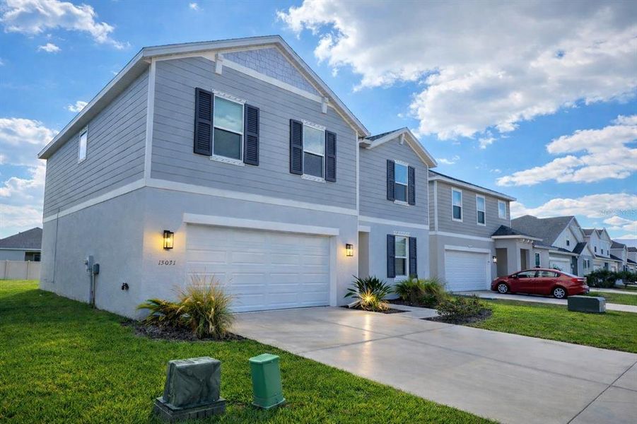 Front exterior of a new home in Broadleaf, Parrish, FL, highlighting curb appeal (Image 31).