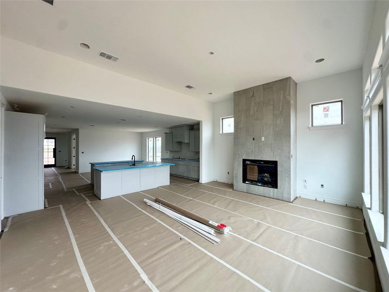 Unfurnished living room featuring healthy amount of natural light and a fireplace