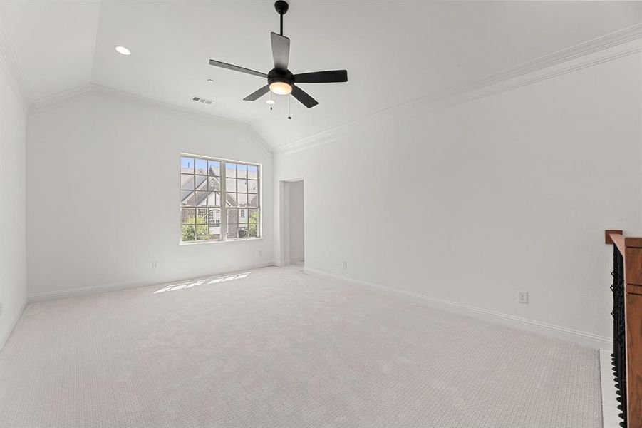 Empty room featuring ornamental molding, lofted ceiling, carpet, a ceiling fan, and recessed lighting Empty room featuring ornamental molding, lofted ceiling, carpet, a ceiling fan, and recessed lighting