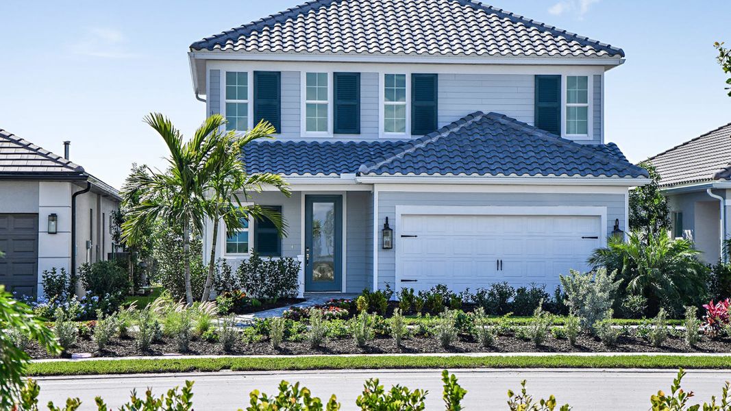 Front exterior of a new home in SkySail Real Estate and Homes for Sale in Naples, FL - Neal Communities, Naples, FL, highlighting curb appeal (Image 18).