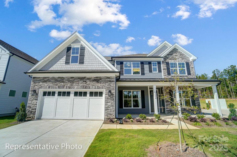 Charleston E elevation on Homesite 37 with front-load garage.