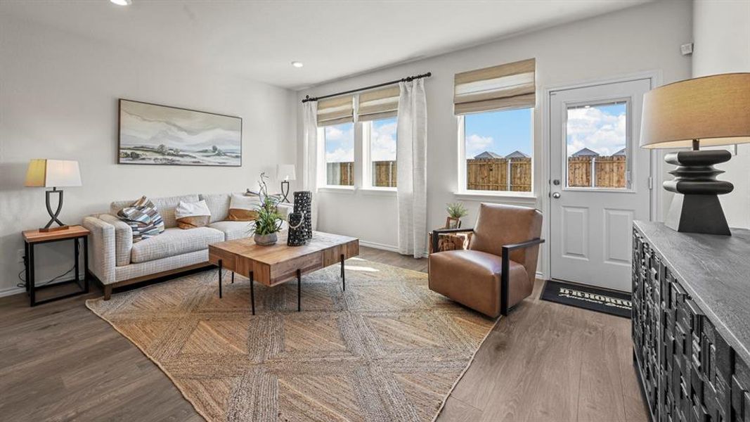 Living room featuring dark wood-style floors and recessed lighting