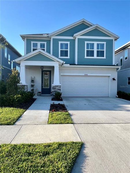 Front exterior of a new home in Persimmon Park - Garden Series, Wesley Chapel, FL, highlighting curb appeal (Image 2). Front exterior of a new home in Persimmon Park - Garden Series, Wesley Chapel, FL, highlighting curb appeal (Image 2).