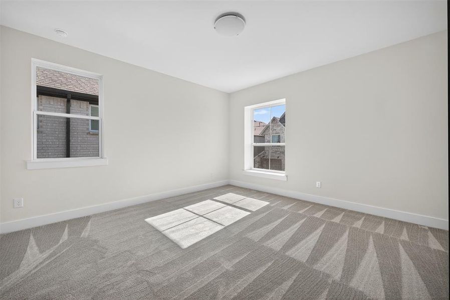 Empty room with light carpet and baseboards Empty room with light carpet and baseboards