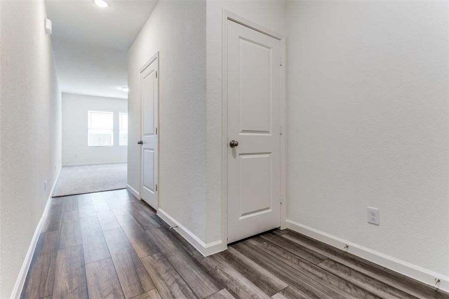 Hall featuring dark wood-type flooring