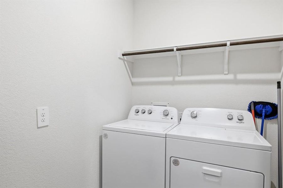 Utility room with a wall of shelves for extra storage