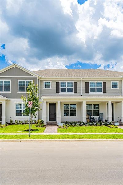 Front exterior of a new home in Osprey Ranch Townhomes, Winter Garden, FL, highlighting curb appeal (Image 17).