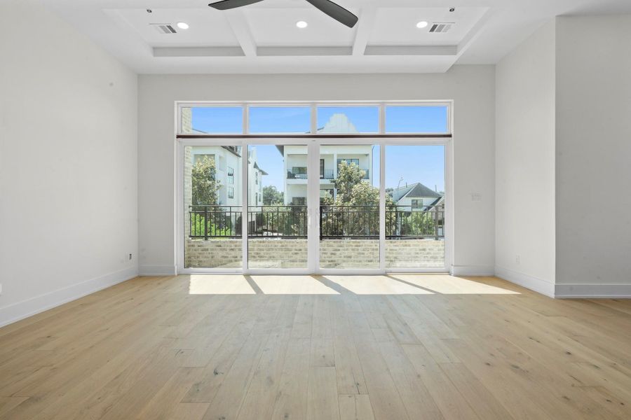 View from the kitchen into the living room and blacony. - Your view from the dining room to the living room with access to your balcony. -  Come tour our furnished model home open Saturday & SundayEstimated completion November 30, 2025.