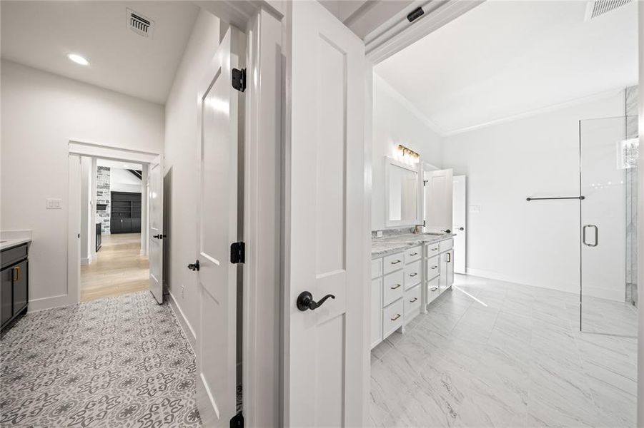 Bathroom featuring double vanity and a shower stall