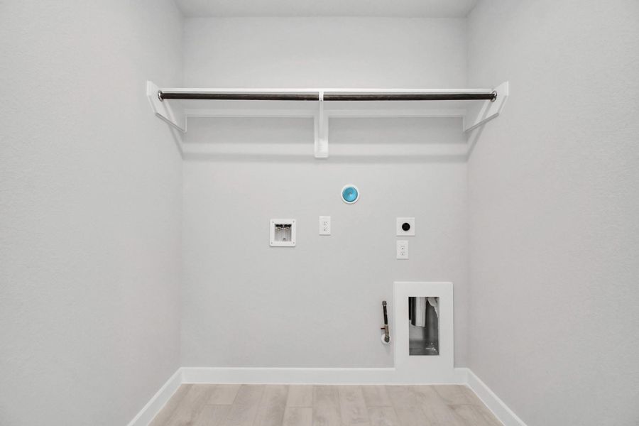 A perfect blend of functionality and comfort. Capture the essence of easy living with a first-floor laundry room, thoughtfully equipped with shelving for effortless organization. Both electric and gas connections available.