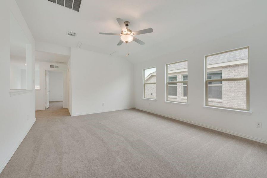 Unfurnished room featuring light colored carpet and a ceiling fan Unfurnished room featuring light colored carpet and a ceiling fan