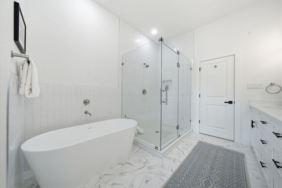 The primary glass surround shower is huge with a stunning free-standing tub.