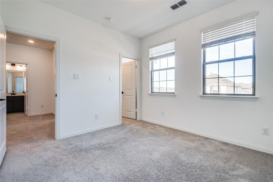 Unfurnished bedroom featuring light carpet