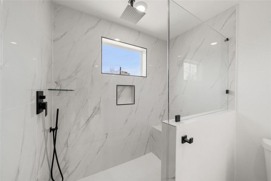 Spa-inspired primary bathroom featuring a dual-sink vanity, quartz countertops, sleek black fixtures, and a walk-in glass shower with modern tile surround. Spa-inspired primary bathroom featuring a dual-sink vanity, quartz countertops, sleek black fixtures, and a walk-in glass shower with modern tile surround.