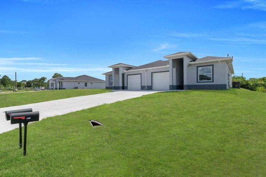 Front exterior of a new home in , Lehigh Acres, FL, highlighting curb appeal (Image 27).