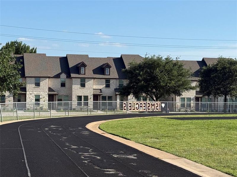 View of front of townhome from Indian Springs football field and track. View of front of townhome from Indian Springs football field and track.