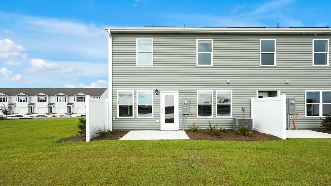 Exterior details and patio area of a home in The Townes at Cedar Hill Landing, Navassa (Image 3).