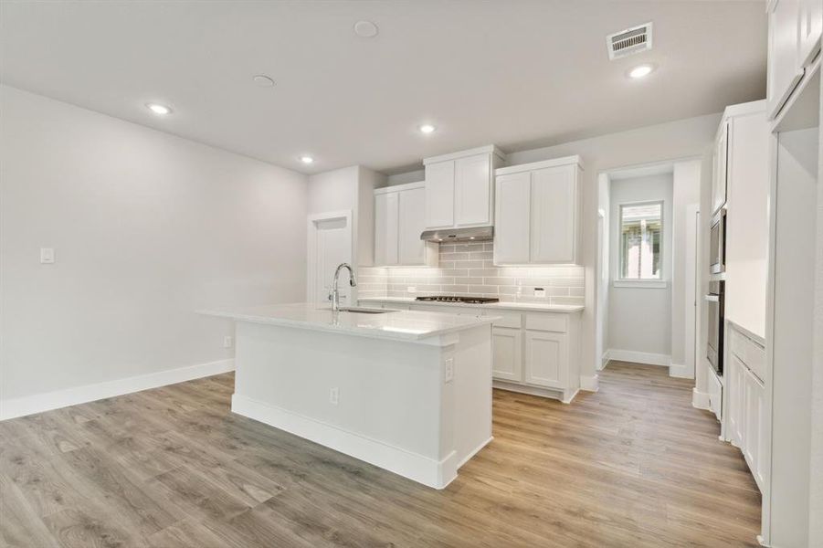 Kitchen with white cabinets, dark hardwood / wood-style floors, sink, and stainless steel appliances