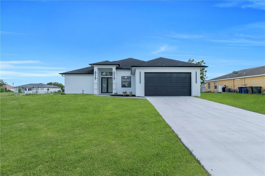 Front exterior of a new home in , Lehigh Acres, FL, highlighting curb appeal (Image 19). Front exterior of a new home in , Lehigh Acres, FL, highlighting curb appeal (Image 19).