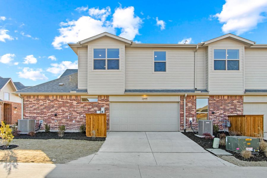 Front exterior of a new home in Cottonwood Creek, Rowlett, TX, highlighting curb appeal (Image 25). Front exterior of a new home in Cottonwood Creek, Rowlett, TX, highlighting curb appeal (Image 25).