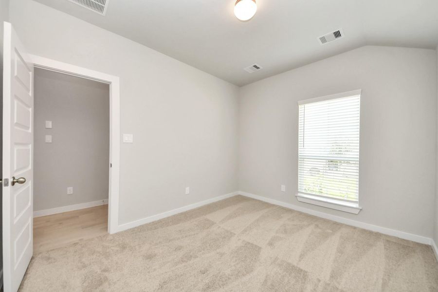 Generously sized secondary bedrooms featuring spacious closets, soft and inviting carpeting underfoot, large windows allowing plenty of natural light, and the added touch of privacy blinds for your personal retreat. Sample photo of completed home with similar floor plan. Actual colors and selections may vary.