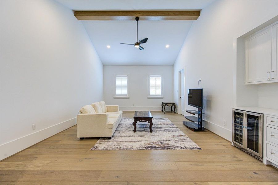 Large game room with built-in cabinets and wine & beverage cooler.