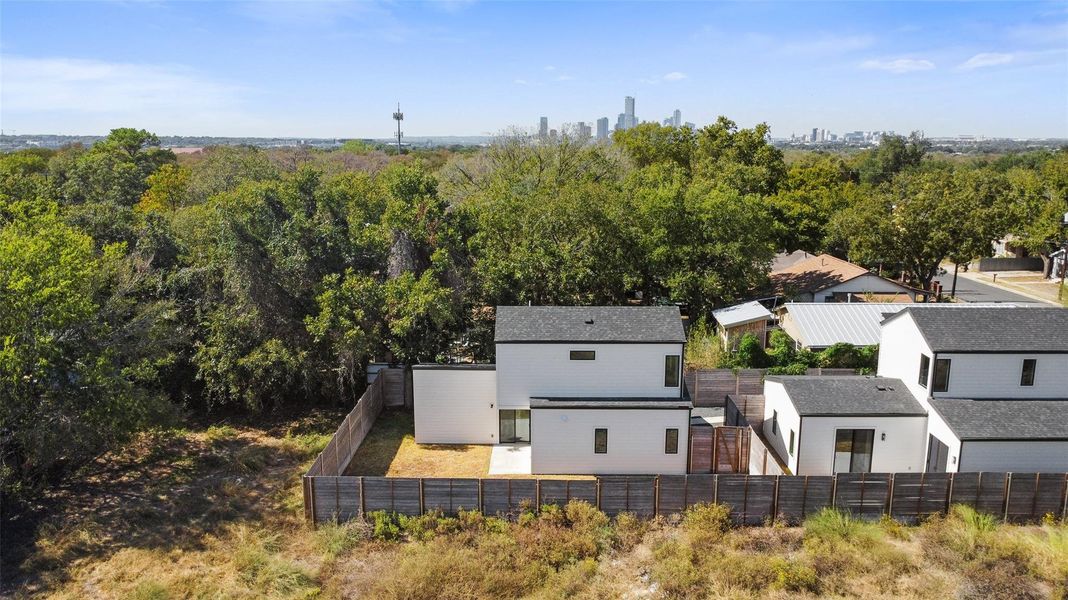 Aerial view of property and surrounding area featuring city skyline Aerial view of property and surrounding area featuring city skyline