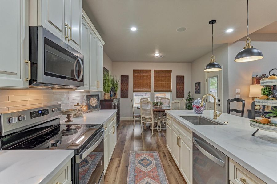 From this vantage point, enjoy the open transition from the kitchen into the breakfast room, designed for the effortless everyday living. From this vantage point, enjoy the open transition from the kitchen into the breakfast room, designed for the effortless everyday living.