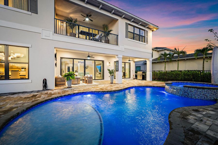 Heated pool with an extended deck, large covered patio, and 2nd-floor verandah.