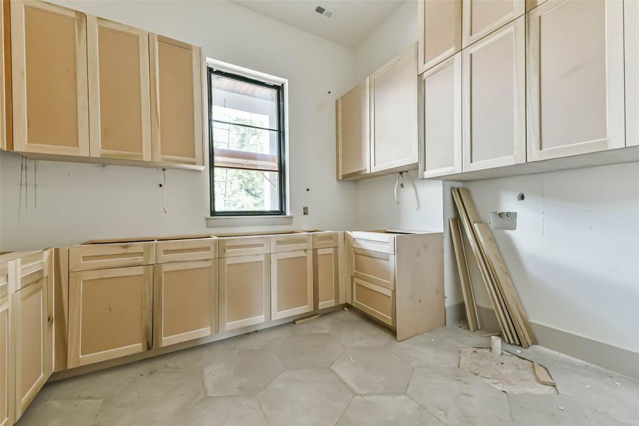 May 26th view of progress in the utility room of your dreams. Incredible storage and ample counter space for folding and organizing your clothing.