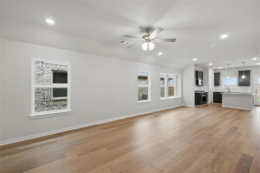 Unfurnished living room featuring recessed lighting, light wood-style floors, and ceiling fan
