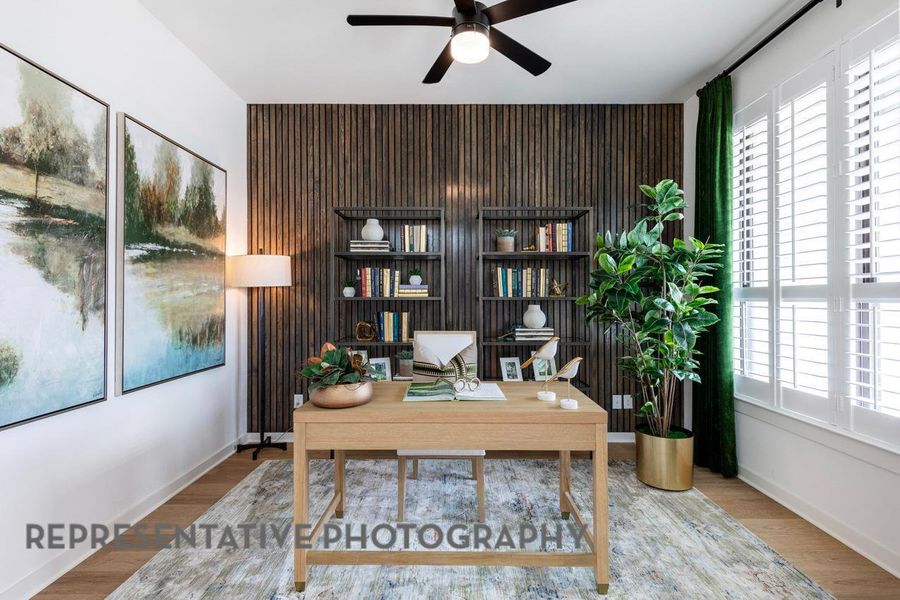 Home office featuring ceiling fan, wood finished floors, and baseboards