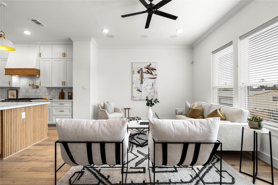 The living room is stylishly furnished with neutral tones and contemporary decor.