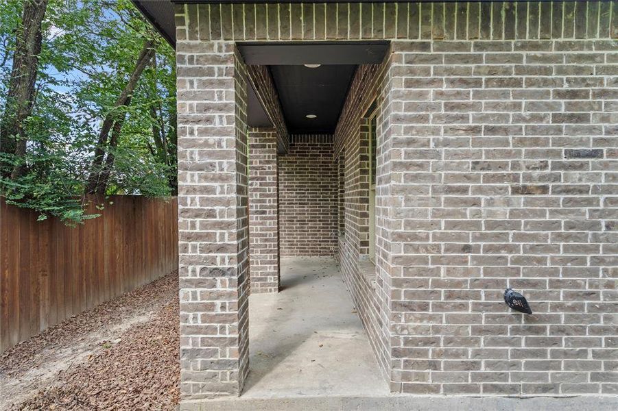 Property entrance featuring brick siding Property entrance featuring brick siding