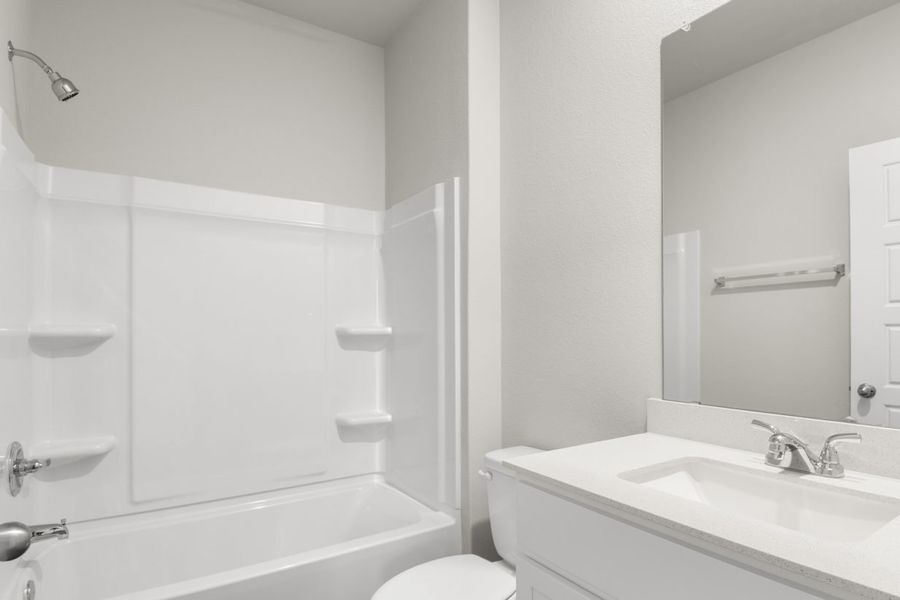 Image of bathroom with white cabinets and a shower with a tub