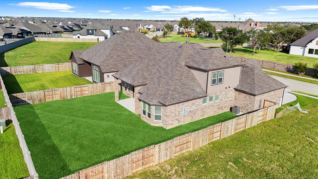 Aerial perspective of the backyard showcases the spacious lot, privacy fencing, and plenty of room for play or gardening.  No flooding during any of the storms.