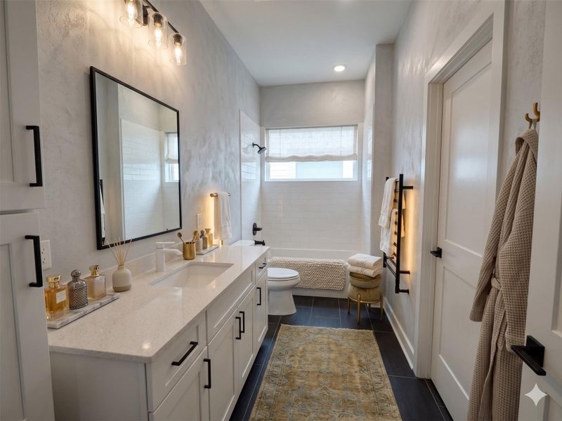 This is a modern bathroom featuring a sleek white vanity with dual sinks, black hardware, and ample cabinet storage. It includes a large mirror with stylish lighting, a tub with a window above, and a cozy ambiance with neutral tones and tasteful decor.