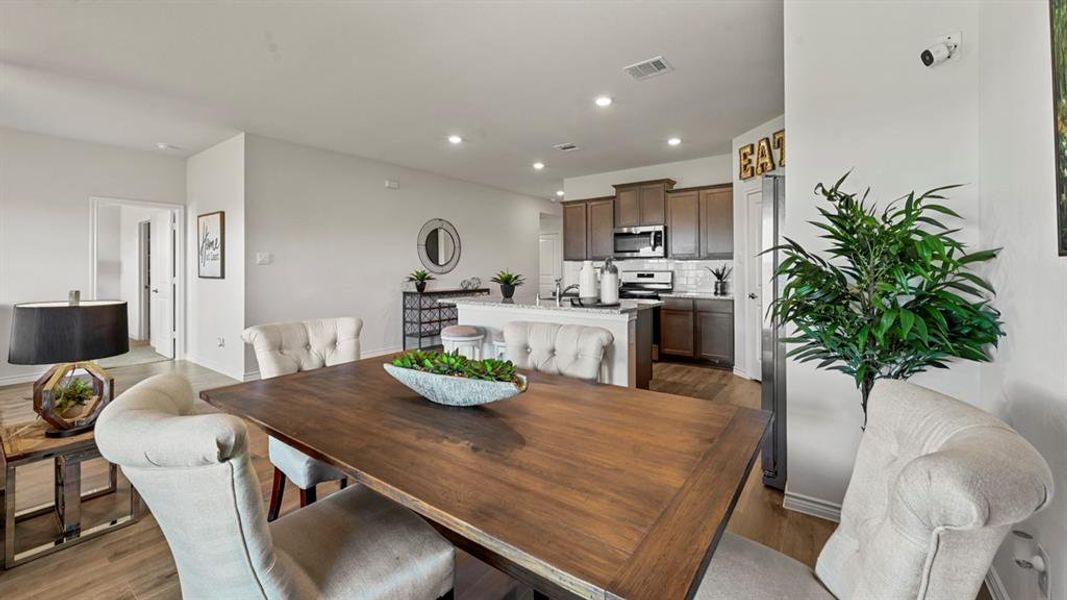 Dining space with recessed lighting and dark wood finished floors