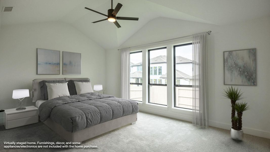 Bedroom with carpet floors, vaulted ceiling, and ceiling fan Bedroom with carpet floors, vaulted ceiling, and ceiling fan